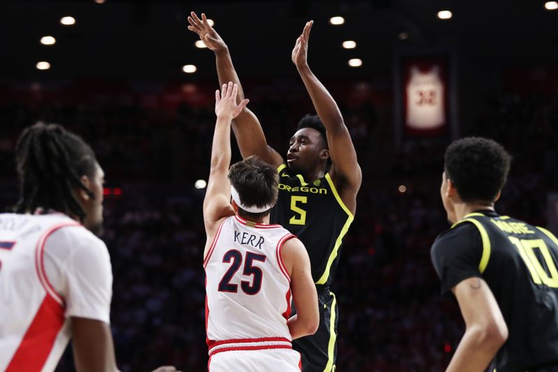 Feb 2, 2023; Tucson, Arizona, USA; Oregon Ducks guard Jermaine Couisnard (5) makes a basket against Arizona Wildcats guard Kerr Kriisa (25) in the first half at McKale Center. Mandatory Credit: Zachary BonDurant-USA TODAY Sports