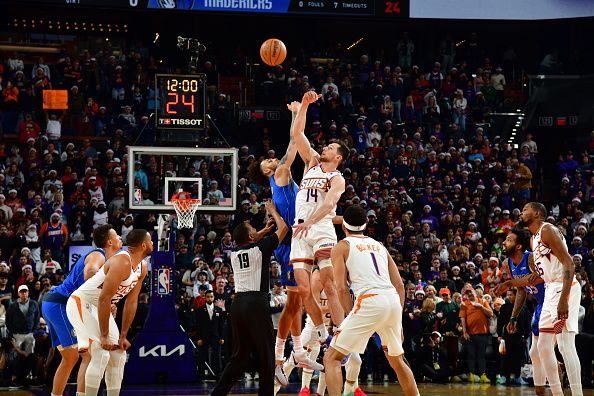 PHOENIX, AZ - DECEMBER 25: Dereck Lively II #2 of the Dallas Mavericks and Drew Eubanks #14 of the Phoenix Suns go up for the opening tip off on December 25, 2023 at Footprint Center in Phoenix, Arizona. NOTE TO USER: User expressly acknowledges and agrees that, by downloading and or using this photograph, user is consenting to the terms and conditions of the Getty Images License Agreement. Mandatory Copyright Notice: Copyright 2023 NBAE (Photo by Kate Frese/NBAE via Getty Images)