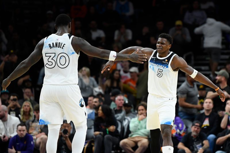 PHOENIX, ARIZONA - MARCH 02: Anthony Edwards #5 of the Minnesota Timberwolves high fives Julius Randle #30 during the second half of the NBA game against the Phoenix Suns at PHX Arena on March 02, 2025 in Phoenix, Arizona. NOTE TO USER: User expressly acknowledges and agrees that, by downloading and or using this photograph, User is consenting to the terms and conditions of the Getty Images License Agreement. (Photo by Kelsey Grant/Getty Images)