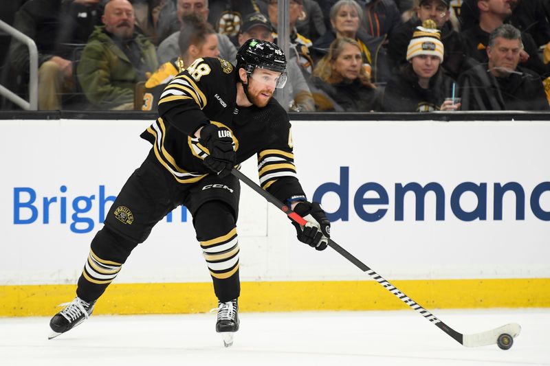 Jan 4, 2024; Boston, Massachusetts, USA; Boston Bruins defenseman Matt Grzelcyk (48) passes the puck during the second period against the Pittsburgh Penguins at TD Garden. Mandatory Credit: Bob DeChiara-USA TODAY Sports