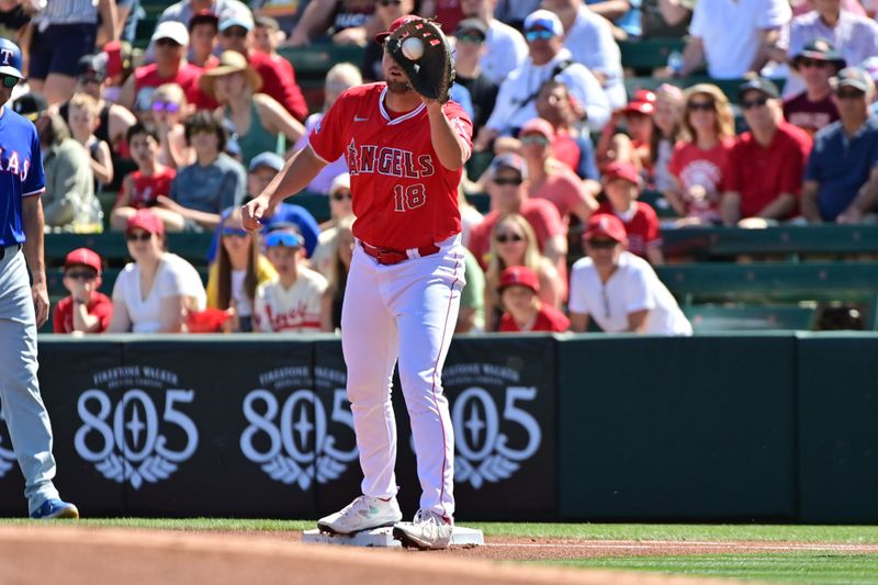 Mar 11, 2024; Tempe, Arizona, USA;  Los Angeles Angels first baseman Nolan Schanuel (18) catches the ball for an out in the first inning against the Texas Rangers during a spring training game at Tempe Diablo Stadium. Mandatory Credit: Matt Kartozian-USA TODAY Sports