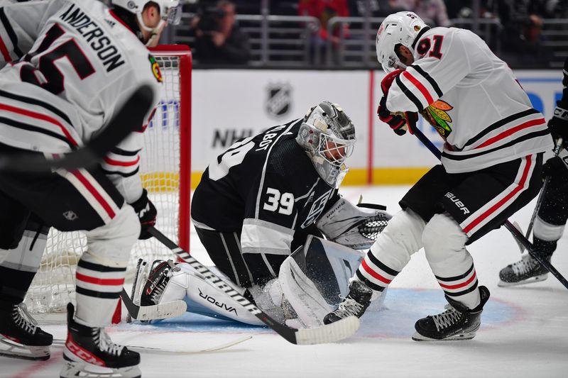 Apr 18, 2024; Los Angeles, California, USA; Los Angeles Kings goaltender Cam Talbot (39) defends the goal against Chicago Blackhawks center Frank Nazar (91) during the third period at Crypto.com Arena. Mandatory Credit: Gary A. Vasquez-USA TODAY Sports