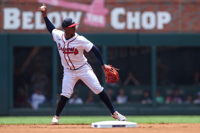 Jul 7, 2024; Atlanta, Georgia, USA; Atlanta Braves second baseman Ozzie Albies (1) throws a runner out at first against the Philadelphia Phillies in the first inning at Truist Park. Mandatory Credit: Brett Davis-USA TODAY Sports
