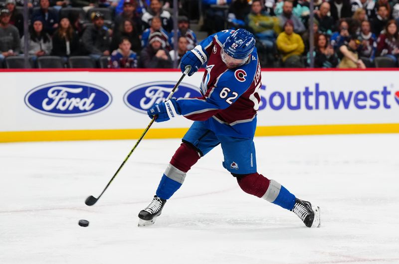 Nov 5, 2024; Denver, Colorado, USA; Colorado Avalanche left wing Artturi Lehkonen (62) shoots and scores in the second period against the Seattle Kraken at Ball Arena. Mandatory Credit: Ron Chenoy-Imagn Images