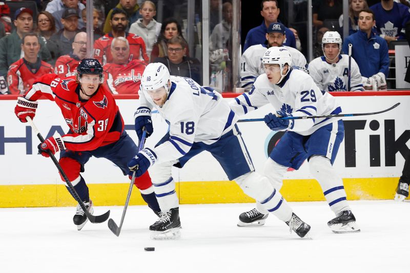 Nov 13, 2024; Washington, District of Columbia, USA; Toronto Maple Leafs center Steven Lorentz (18) skates with the puck as Washington Capitals defenseman Rasmus Sandin (38) defends in the second period at Capital One Arena. Mandatory Credit: Geoff Burke-Imagn Images