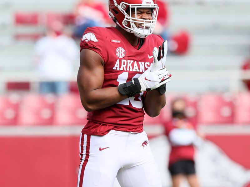 Oct 17, 2020; Fayetteville, Arkansas, USA; Arkansas Razorbacks defensive lineman Julius Coates (13) celebrates after sacking Ole Miss Rebels quarterback Matt Corral (2) during the first quarter at Donald W. Reynolds Razorback Stadium. Mandatory Credit: Nelson Chenault-USA TODAY Sports