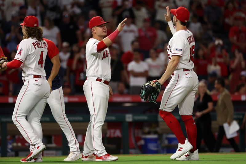 Sep 9, 2023; Anaheim, California, USA;  Los Angeles Angels designated hitter Matt Thaiss (21, center) celebrates a victory with left fielder Randal Grichuk (15) after defeating the Cleveland Guardians 6-2 at Angel Stadium. Mandatory Credit: Kiyoshi Mio-USA TODAY Sports