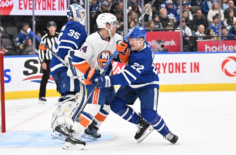 Feb 5, 2024; Toronto, Ontario, CAN;   Toronto Maple Leafs defenseman Jake McCabe (22) tries to move New York Islanders forward Bo Horvat (14) away from goalie Ilya Samsonov in the second. period at Scotiabank Arena. Mandatory Credit: Dan Hamilton-USA TODAY Sports