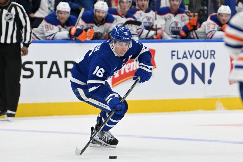 Nov 16, 2024; Toronto, Ontario, CAN; Toronto Maple Leafs forward Mitch Marner (16) skates with the puck against the Edmonton Oilers in the third period at Scotiabank Arena. Mandatory Credit: Dan Hamilton-Imagn Images