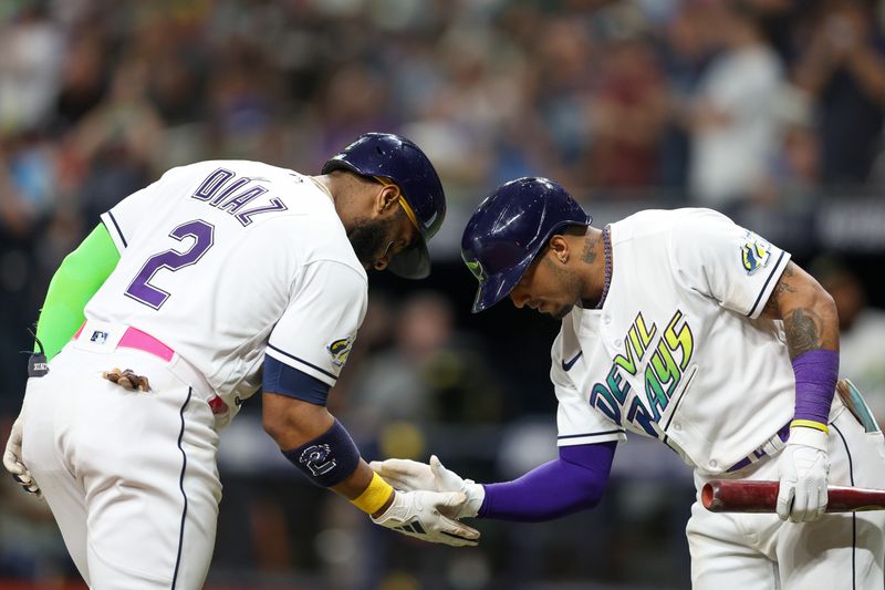 May 26, 2023; St. Petersburg, Florida, USA;  Tampa Bay Rays shortstop Wander Franco (5) congratulates first baseman Yandy Diaz (2) after hitting a home run against the Los Angeles Dodgers in the fourth inning at Tropicana Field. Mandatory Credit: Nathan Ray Seebeck-USA TODAY Sports