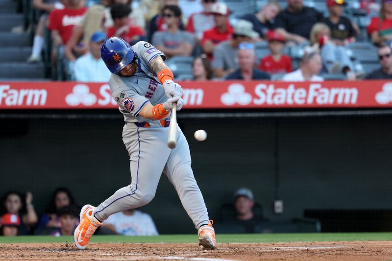 Aug 2, 2024; Anaheim, California, USA;  New York Mets catcher Francisco Alvarez (4) hits an RBI single during the second inning against the Los Angeles Angels at Angel Stadium. Mandatory Credit: Kiyoshi Mio-USA TODAY Sports