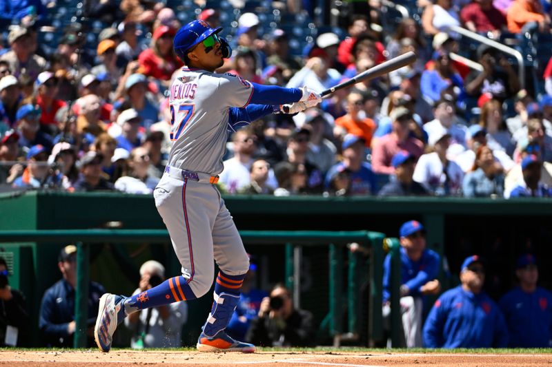 Apr 27, 2025; Washington, District of Columbia, USA; New York Mets third baseman Mark Vientos (27) hits a RBI sacrifice fly against the Washington Nationals during the first inning at Nationals Park. Mandatory Credit: Brad Mills-Imagn Images