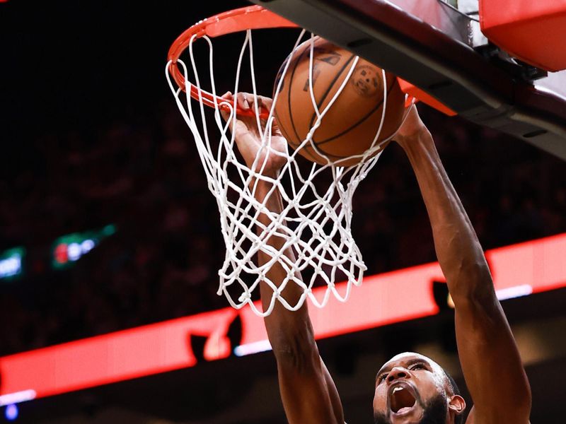 MIAMI, FLORIDA - JANUARY 29: Evan Mobley #4 of the Cleveland Cavaliers dunks the ball ahead of  Tyler Herro #14 of the Miami Heat during the second half at Kaseya Center on January 29, 2025 in Miami, Florida.  NOTE TO USER: User expressly acknowledges and agrees that, by downloading and or using this Photograph, user is consenting to the terms and conditions of the Getty Images License Agreement. (Photo by Carmen Mandato/Getty Images)