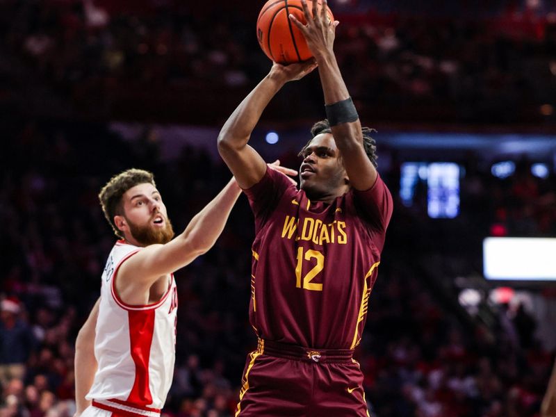 Dec 22, 2025; Tucson, Arizona, USA; Bethune-Cookman Wildcats guard Dailon Minor (12) scores a jumper while Arizona Wildcats guard Anthony Dell’Orso (3) fails to block him during the first half of the game at McKale Memorial Center. Mandatory Credit: Aryanna Frank-Imagn Images