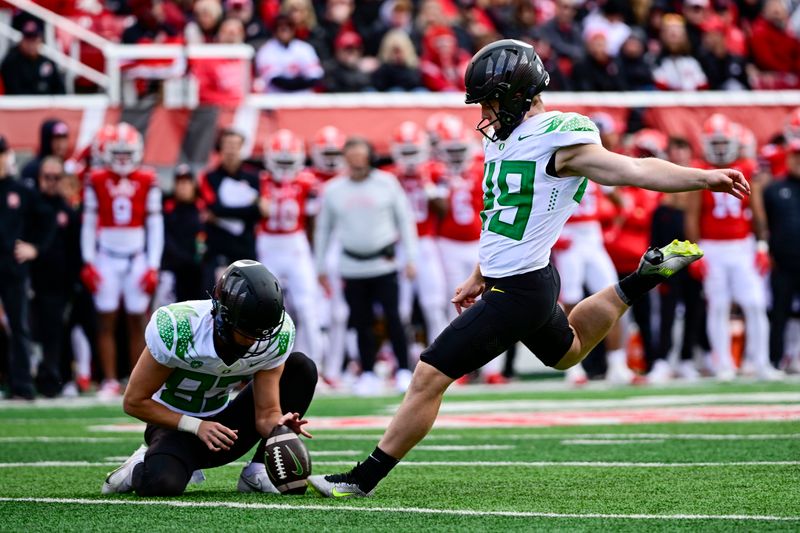 Oct 28, 2023; Salt Lake City, Utah, USA; Oregon Ducks kicker Camden Lewis (49) kicks a PAT against the Utah Utes during the first half at Rice-Eccles Stadium. Mandatory Credit: Christopher Creveling-USA TODAY Sports