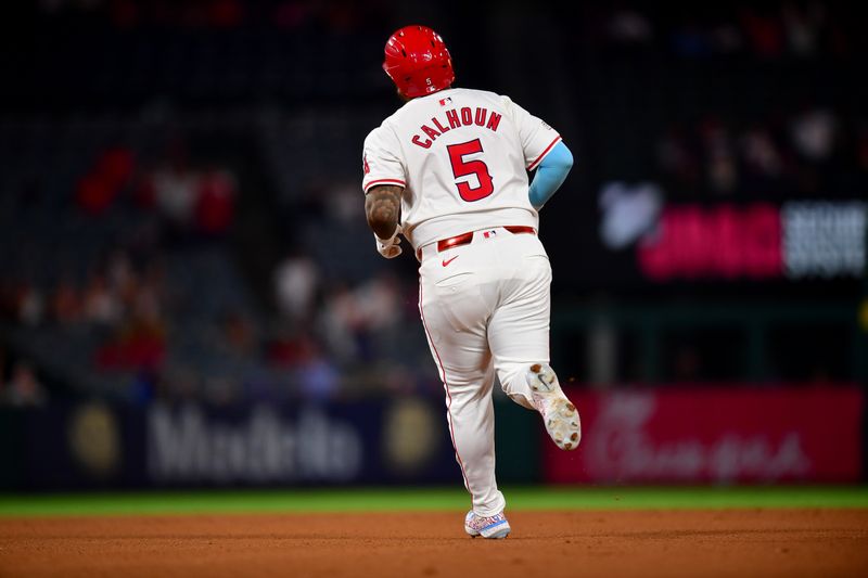 Aug 13, 2024; Anaheim, California, USA; Los Angeles Angels designated hitter Willie Calhoun (5) runs the bases after hitting a solo home run against the Toronto Blue Jays during the ninth inning at Angel Stadium. Mandatory Credit: Gary A. Vasquez-USA TODAY Sports