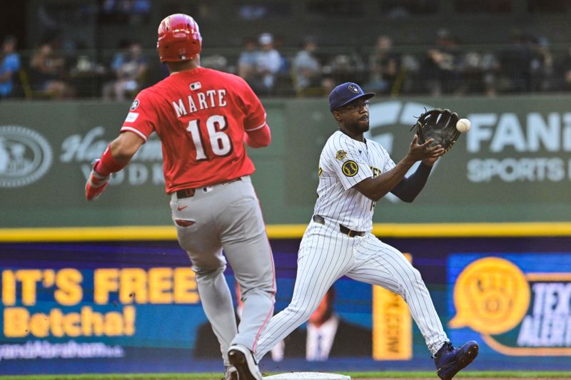 Sep 28, 2025; Milwaukee, Wisconsin, USA;  Milwaukee Brewers shortstop Andruw Monasterio (14) forces out Cincinnati Reds right fielder Noelvi Marte (16) before completing a double play in the third inning at American Family Field. Mandatory Credit: Benny Sieu-Imagn Images