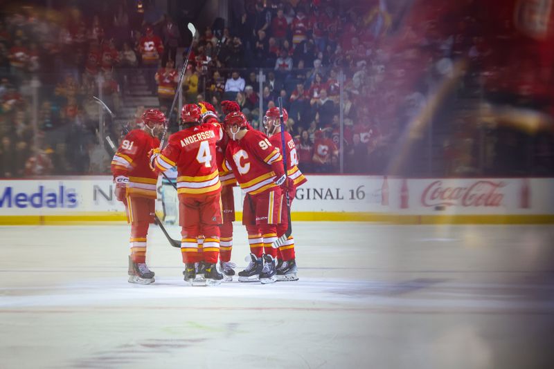 Mar 4, 2024; Calgary, Alberta, CAN; Calgary Flames left wing Andrei Kuzmenko (96) celebrates his goal with teammates against the Seattle Kraken during the third period at Scotiabank Saddledome. Mandatory Credit: Sergei Belski-USA TODAY Sports