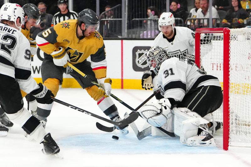 Feb 5, 2026; Las Vegas, Nevada, USA; Los Angeles Kings goaltender Anton Forsberg (31) defends his net as Vegas Golden Knights defenseman Jeremy Lauzon (5) looks to control a loose puck during the second period at T-Mobile Arena. Mandatory Credit: Stephen R. Sylvanie-Imagn Images