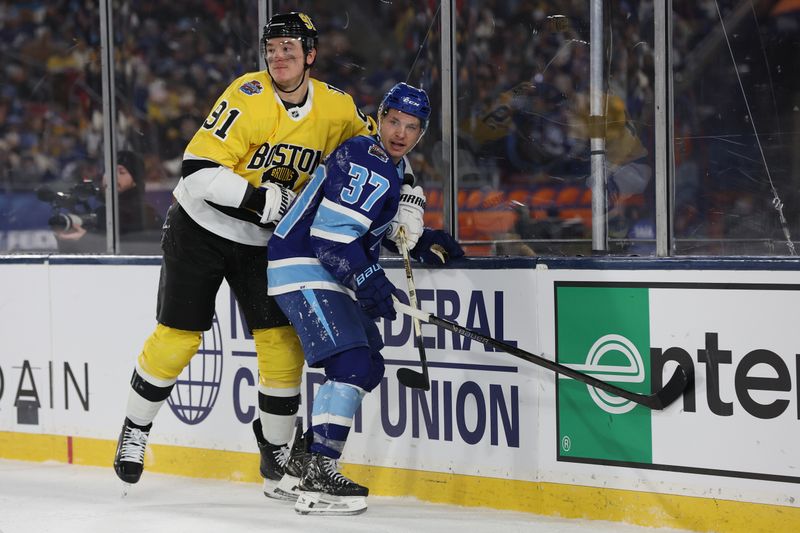 Feb 1, 2026; Tampa Bay, Florida, USA; Boston Bruins defenseman Nikita Zadorov (91) and Tampa Bay Lightning center Yanni Gourde (37) watch the action from the boards during the second period in the 2026 Stadium Series ice hockey game at Raymond James Stadium. Mandatory Credit: Kim Klement Neitzel-Imagn Images