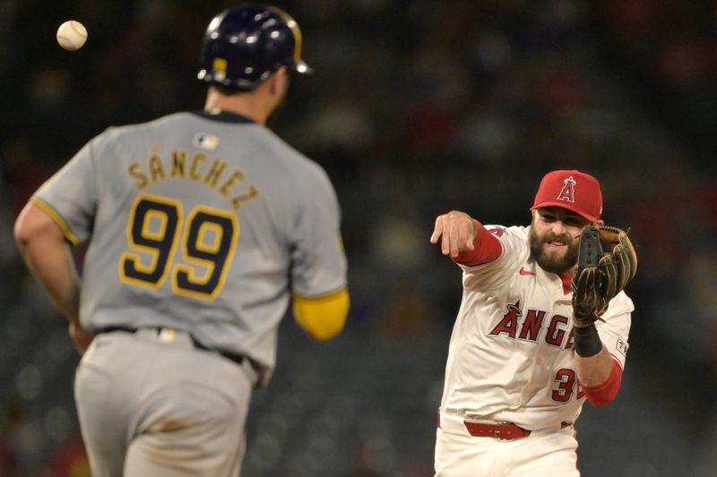 Jun 19, 2024; Anaheim, California, USA; Milwaukee Brewers catcher Gary Sanchez (99) is out as Los Angeles Angels second baseman Michael Stefanic (38) throws to first for a double play in the ninth inning at Angel Stadium. Mandatory Credit: Jayne Kamin-Oncea-USA TODAY Sports