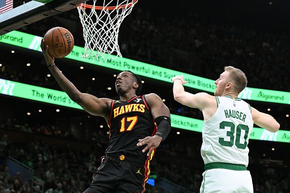 BOSTON, MASSACHUSETTS - NOVEMBER 26:  Onyeka Okongwu #17 of the Atlanta Hawks drives to the basket against Sam Hauser #30 of the Boston Celtics during the second quarter at the TD Garden on November 26, 2023 in Boston, Massachusetts. NOTE TO USER: User expressly acknowledges and agrees that, by downloading and or using this photograph, User is consenting to the terms and conditions of the Getty Images License Agreement. (Photo by Brian Fluharty/Getty Images)