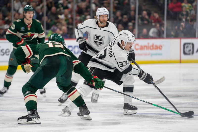 Feb 21, 2023; Saint Paul, Minnesota, USA; Los Angeles Kings right wing Viktor Arvidsson (33) tries to skate by Minnesota Wild left wing Matt Boldy (12) in the third period at Xcel Energy Center. Mandatory Credit: Matt Blewett-USA TODAY Sports