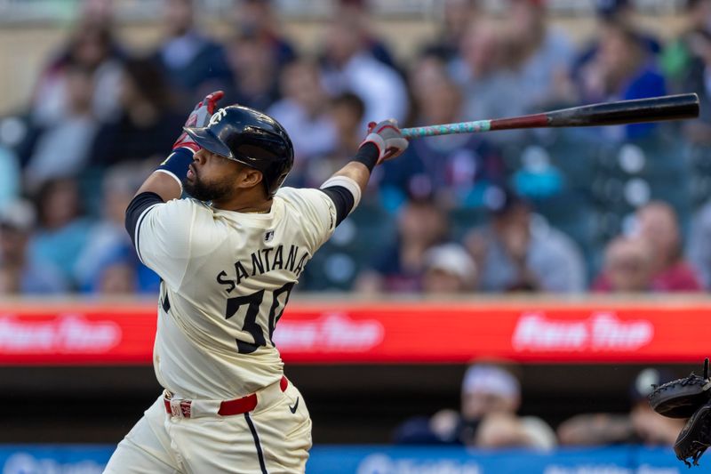 May 29, 2024; Minneapolis, Minnesota, USA; Minnesota Twins first baseman Carlos Santana (30) hits a single against the Kansas City Royals in the second inning at Target Field. Mandatory Credit: Jesse Johnson-USA TODAY Sports