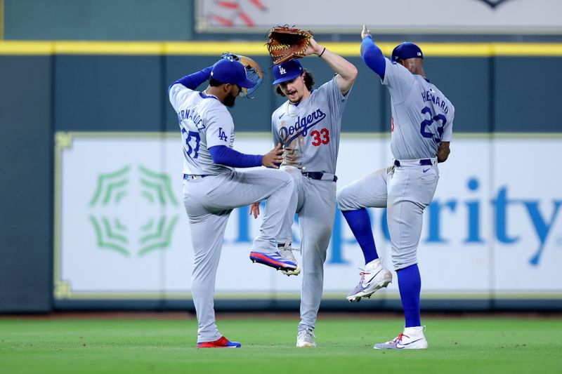 Jul 28, 2024; Houston, Texas, USA; The Los Angeles Dodgers outfielders celebrate after the final out against the Houston Astros during the ninth inning at Minute Maid Park. Mandatory Credit: Erik Williams-USA TODAY Sports
