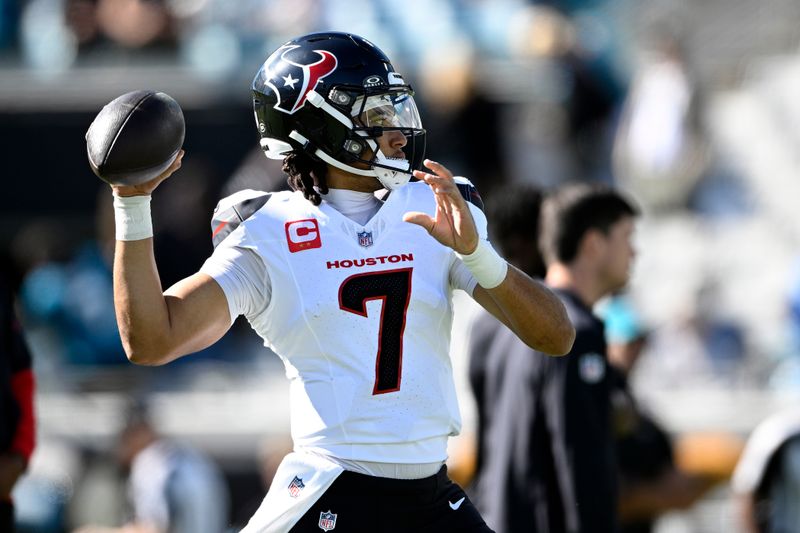 Houston Texans quarterback C.J. Stroud warms up before an NFL football game against the Jacksonville Jaguars Sunday, Dec. 1, 2024, in Jacksonville, Fla. (AP Photo/Phelan M. Ebenhack)