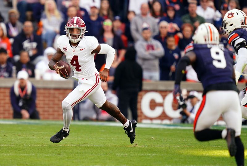 Nov 25, 2023; Auburn, Alabama, USA; Alabama Crimson Tide quarterback Jalen Milroe (4) scrambles up the field against the Auburn Tigers during the first quarter at Jordan-Hare Stadium. Mandatory Credit: John David Mercer-USA TODAY Sports