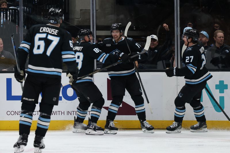 Dec 29, 2025; Salt Lake City, Utah, USA; The Utah Mammoth celebrate a goal by right wing Dylan Guenther (11) against the Nashville Predators during the third period at Delta Center. Mandatory Credit: Rob Gray-Imagn Images