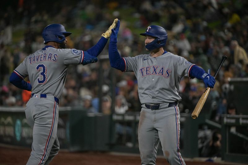 Apr 24, 2025; West Sacramento, California, USA; Texas Rangers outfielder Leody Taveras (3) high fives outfielder Wyatt Langford (36) after hitting a home run against the Athletics during the fourth inning at Sutter Health Park. Mandatory Credit: Ed Szczepanski-Imagn Images
