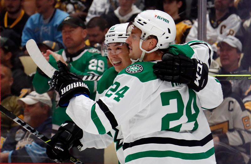 Oct 24, 2023; Pittsburgh, Pennsylvania, USA; Dallas Stars left wing Jason Robertson (left) celebrates with center Roope Hintz (24) after Robertson scored a goal against the Pittsburgh Penguins during the second period at PPG Paints Arena. Mandatory Credit: Charles LeClaire-USA TODAY Sports