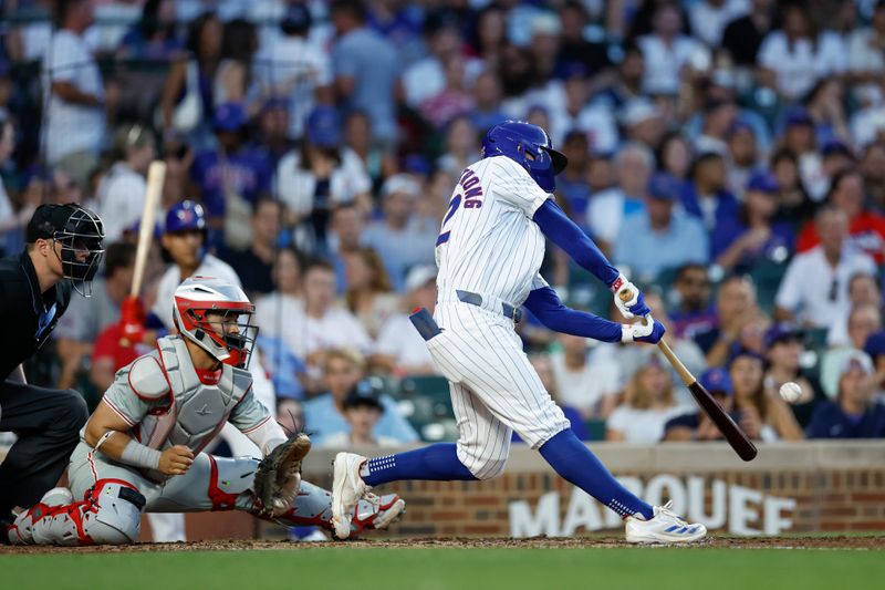 Jul 3, 2024; Chicago, Illinois, USA; Chicago Cubs outfielder Pete Crow-Armstrong (52) hits an RBI-double against the Philadelphia Phillies during the fourth inning at Wrigley Field. Mandatory Credit: Kamil Krzaczynski-USA TODAY Sports