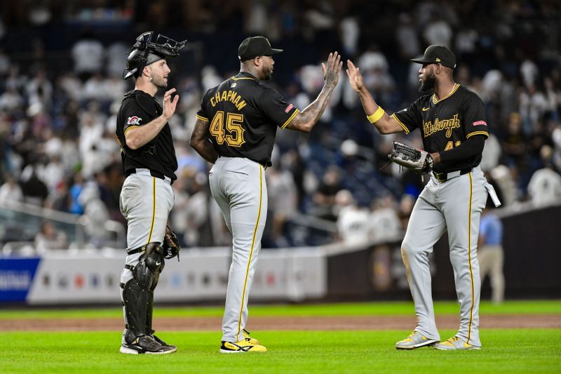 Sep 27, 2024; Bronx, New York, USA; Pittsburgh Pirates pitcher Aroldis Chapman (45) slaps hands with Pittsburgh Pirates outfielder Bryan De La Cruz (41) after winning against the New York Yankees at Yankee Stadium. Mandatory Credit: John Jones-Imagn Images