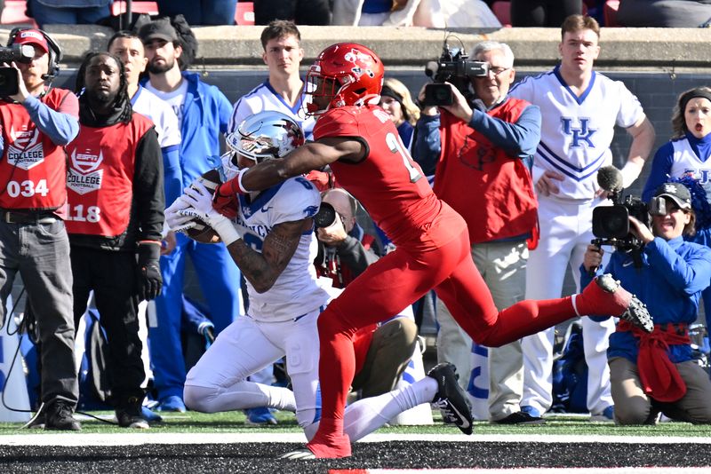 Nov 25, 2023; Louisville, Kentucky, USA;  Kentucky Wildcats wide receiver Dane Key (6) catches a touchdown pass under the pressure of Louisville Cardinals defensive back Storm Duck (29) during the first half at L&N Federal Credit Union Stadium. Mandatory Credit: Jamie Rhodes-USA TODAY Sports