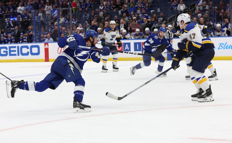 Dec 19, 2023; Tampa, Florida, USA; Tampa Bay Lightning center Anthony Cirelli (71) shoots against the St. Louis Blues during the third period at Amalie Arena. Mandatory Credit: Kim Klement Neitzel-USA TODAY Sports