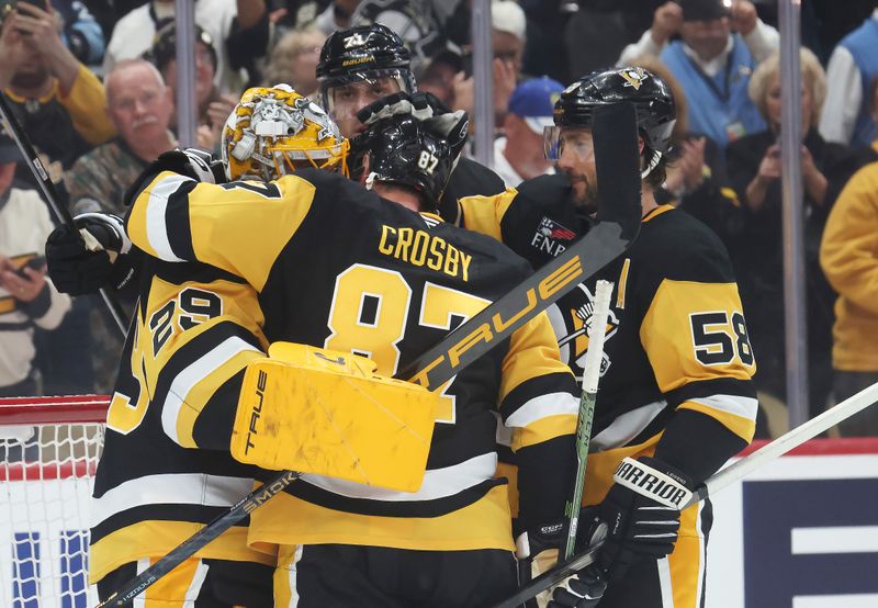 Sep 27, 2025; Pittsburgh, Pennsylvania, USA;  Pittsburgh Penguins goaltender Marc-Andre Fleury (29) is embraced by center Evgeni Malkin (71) and center Sidney Crosby (87) and defenseman Kris Letang (58) after his final NHL game to defeat the Columbus Blue Jackets at PPG Paints Arena. Mandatory Credit: Charles LeClaire-Imagn Images