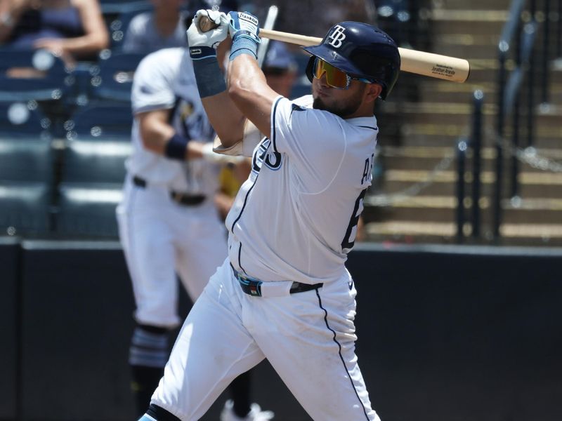 Jun 6, 2025; St. Petersburg, Florida, USA; Tampa Bay Rays first base Jonathan Aranda (62) hits a sacrifice RBI against the Miami Marlins during the third inning at George M. Steinbrenner Field. Mandatory Credit: Kim Klement Neitzel-Imagn Images