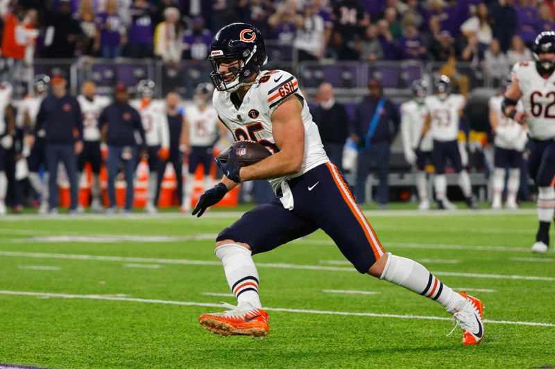 Chicago Bears tight end Cole Kmet (85) runs up field after catching a pass during the first half of an NFL football game against the Minnesota Vikings, Monday, Nov. 27, 2023, in Minneapolis. (AP Photo/Bruce Kluckhohn)