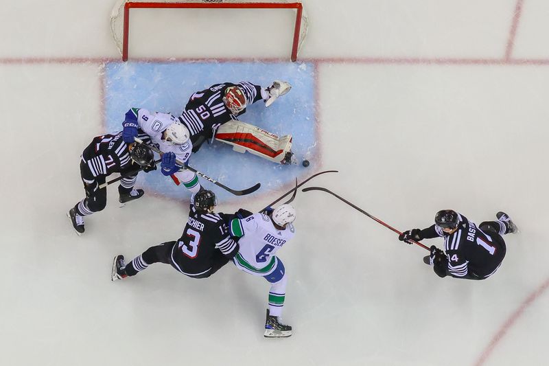 Jan 6, 2024; Newark, New Jersey, USA; New Jersey Devils goaltender Nico Daws (50) makes a save against the Vancouver Canucks during the first period at Prudential Center. Mandatory Credit: Ed Mulholland-USA TODAY Sports