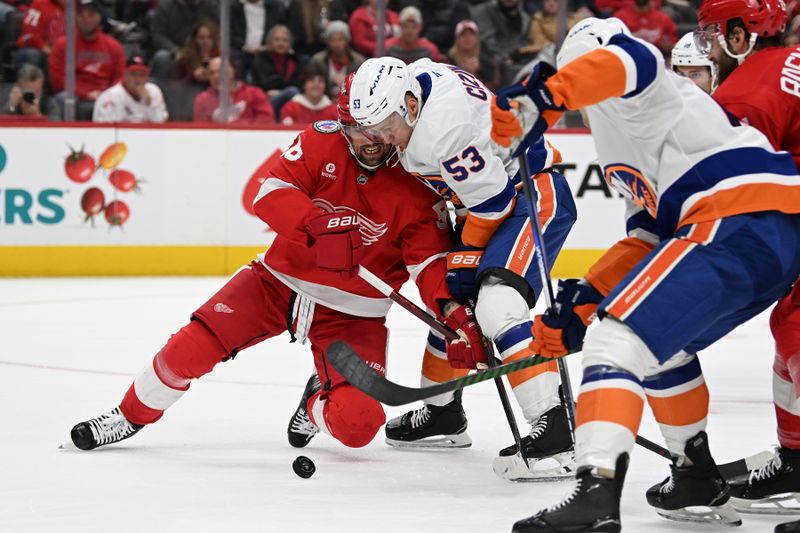 Nov 21, 2024; Detroit, Michigan, USA;  Detroit Red Wings defenseman Erik Gustafsson (56) and New York Islanders center Casey Cizikas (53) battle for the puck in the first period at Little Caesars Arena. Mandatory Credit: Lon Horwedel-Imagn Images