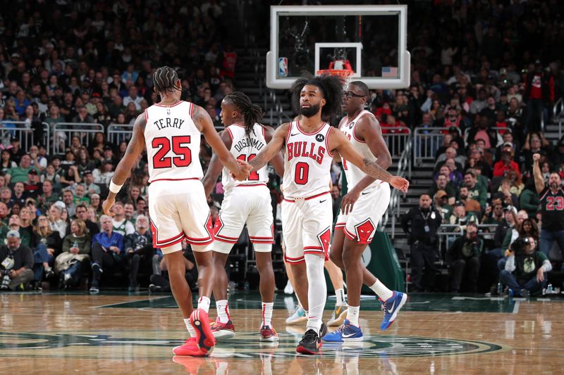 MILWAUKEE, WI - OCTOBER 25: Coby White #0 of the Chicago Bulls high fives Dalen Terry #25 during the game against the Milwaukee Bucks on October 25, 2024 at the Fiserv Forum Center in Milwaukee, Wisconsin. NOTE TO USER: User expressly acknowledges and agrees that, by downloading and or using this Photograph, user is consenting to the terms and conditions of the Getty Images License Agreement. Mandatory Copyright Notice: Copyright 2024 NBAE (Photo by Gary Dineen/NBAE via Getty Images).