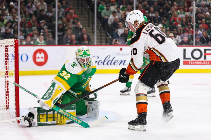 Jan 27, 2024; Saint Paul, Minnesota, USA; Minnesota Wild goaltender Filip Gustavsson (32) makes a save on a shot by Anaheim Ducks defenseman Jackson LaCombe (60) during the first period at Xcel Energy Center. Mandatory Credit: Matt Krohn-USA TODAY Sports