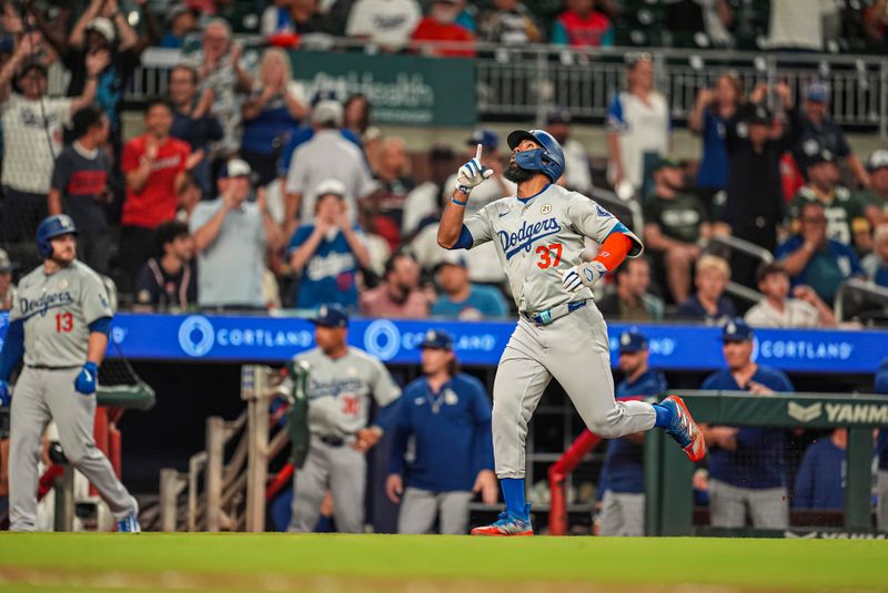 Sep 15, 2024; Cumberland, Georgia, USA; Los Angeles Dodgers left fielder Teoscar Hernandez (37) reacts after hitting a two run home run against the Atlanta Braves during the ninth inning at Truist Park. Mandatory Credit: Dale Zanine-Imagn Images