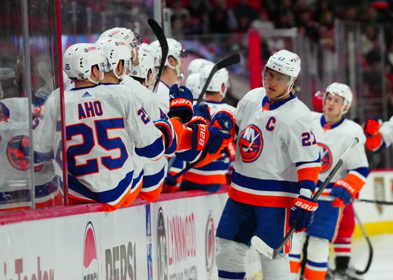 Dec 23, 2023; Raleigh, North Carolina, USA; New York Islanders left wing Anders Lee (27) celebrates his goal against the Carolina Hurricanes during the third period at PNC Arena. Mandatory Credit: James Guillory-USA TODAY Sports