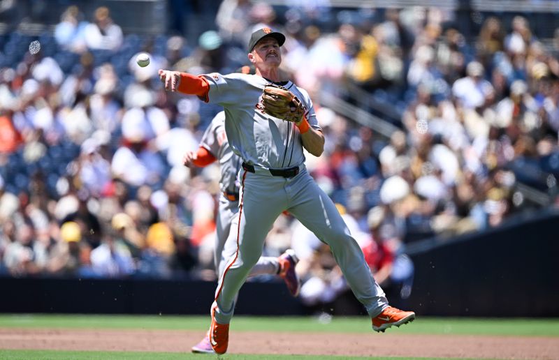 Apr 30, 2025; San Diego, California, USA; San Francisco Giants third baseman Matt Chapman (26) throws to first base but can’t get the out on San Diego Padres right fielder Fernando Tatis Jr. (23) during the first inning at Petco Park. Mandatory Credit: Denis Poroy-Imagn Images