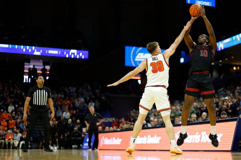 Jan 10, 2026; Charlottesville, Virginia, USA; Stanford Cardinal forward Chisom Okpara (10) shoots the ball as Virginia Cavaliers guard Dallin Hall (30) defends in the first half at John Paul Jones Arena. Mandatory Credit: Geoff Burke-Imagn Images