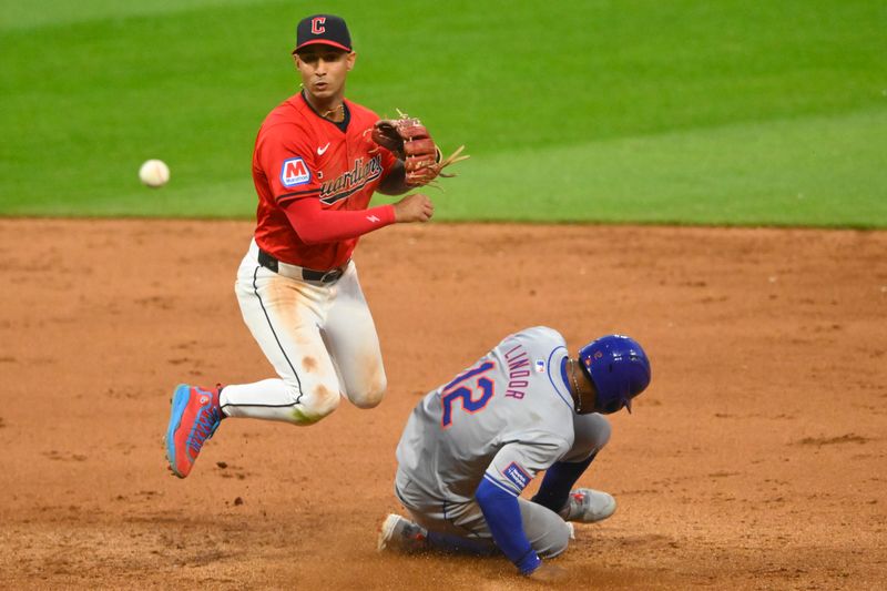 May 21, 2024; Cleveland, Ohio, USA; Cleveland Guardians shortstop Brayan Rocchio (4) turns a game-ending double play beside New York Mets shortstop Francisco Lindor (12) in the ninth inning at Progressive Field. Mandatory Credit: David Richard-USA TODAY Sports